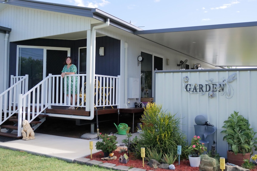 Shane turner stands on the deck of her barcaldine modular house
