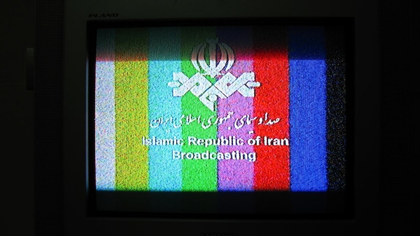 A television shows a station identification image for Islamic Republic of Iran Broadcasting