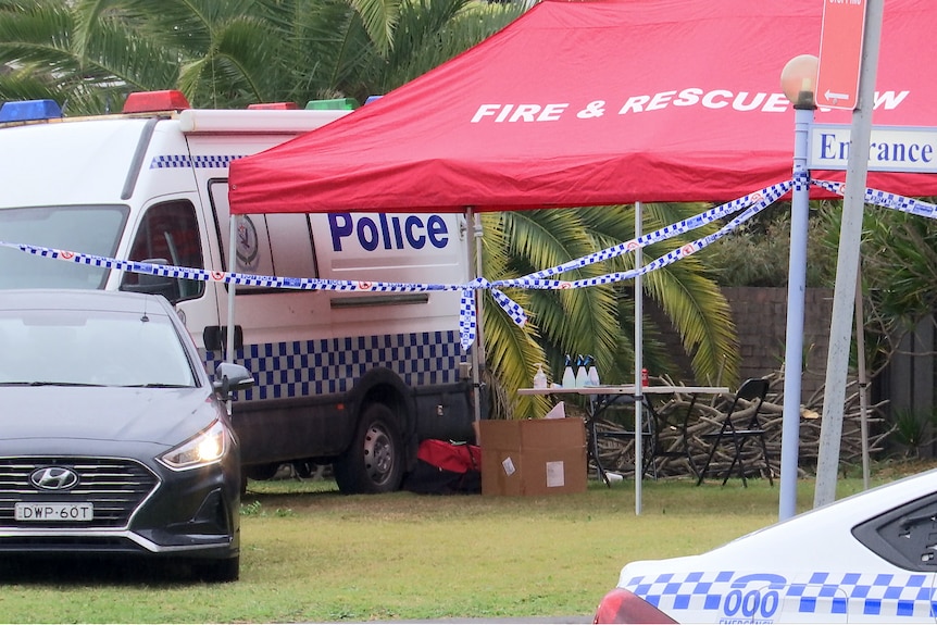 A red fire and rescue marquee surrounded by police vehicles.