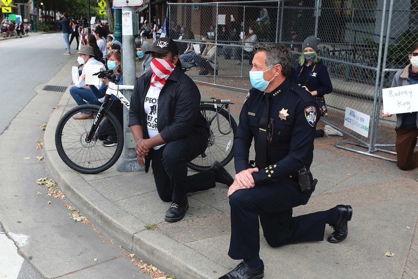 Protesters kneel against police violence against African-Americans following the death of George Floyd.