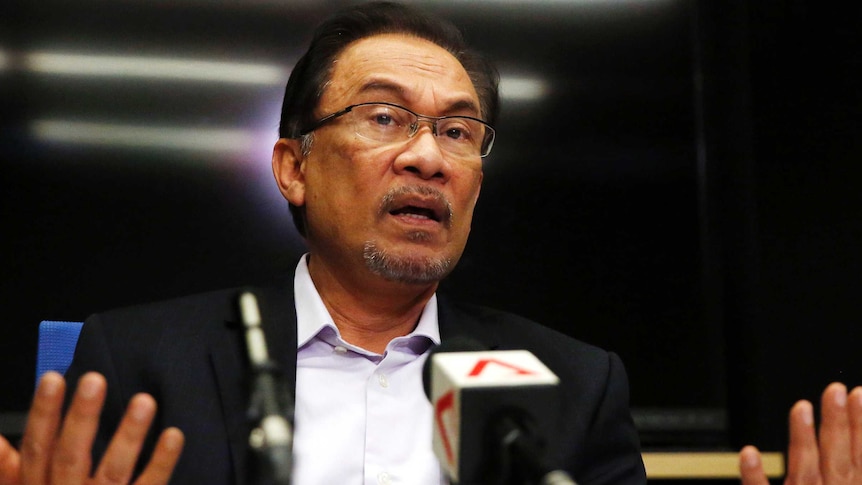 Malaysia's opposition leader Anwar Ibrahim speaks to the media