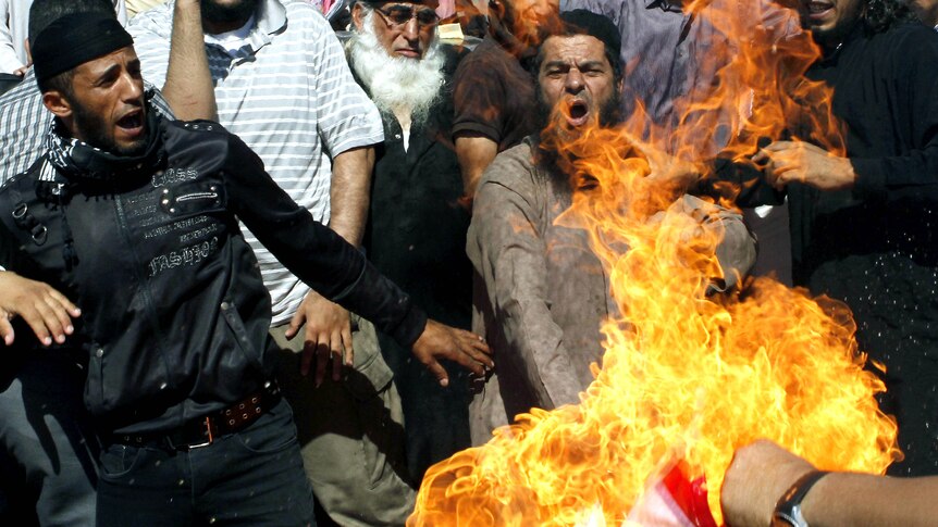 Jordanian protesters burn a US flag