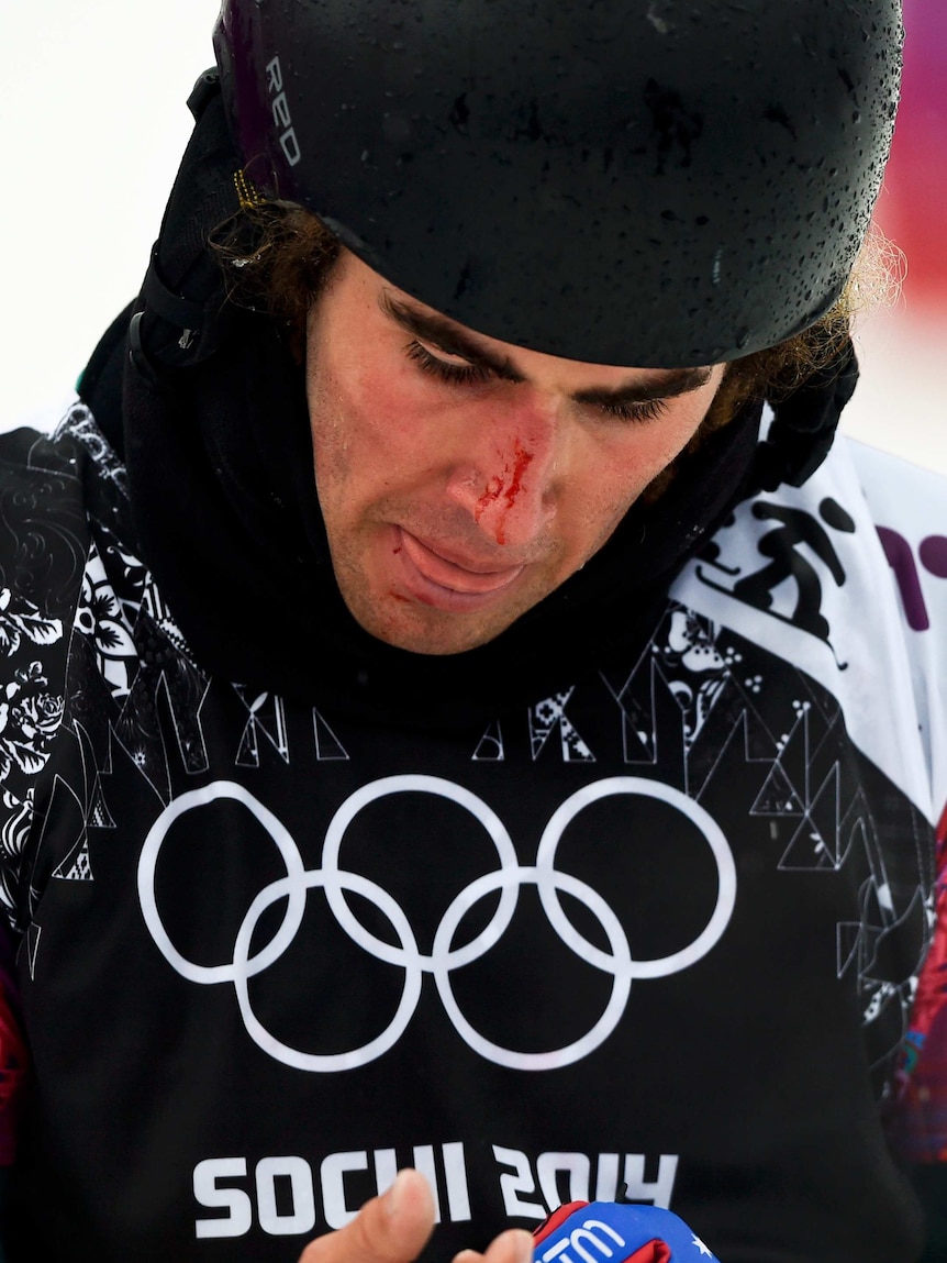 Cam Bolton examines his injured wrist