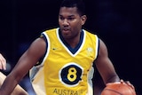Australian basketballer Ricky Grace moves down the court with the ball in hand.