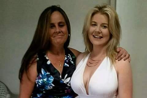 Cassandra pictured with her mother Lisa wearing a white formal dress.