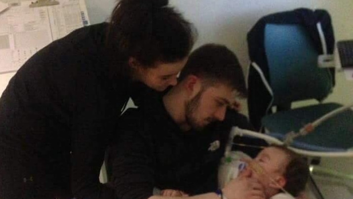 Alfie and his parents in hospital