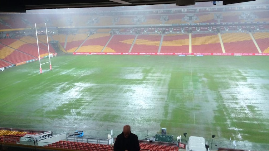 Heavy rain falls pooling at Lang Park ahead of the Australia v New Zealand rugby league Test match.