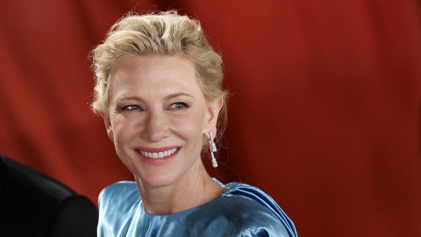 Actor Cate Blanchett smiles while wearing a long gown at the Oscars