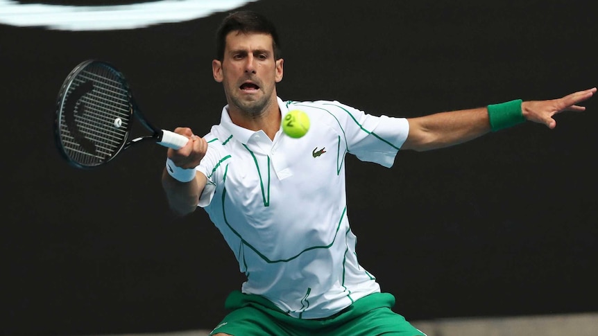 Novak Djokovic slides into a forehand during an Australian Open match against Tatsuma Ito.