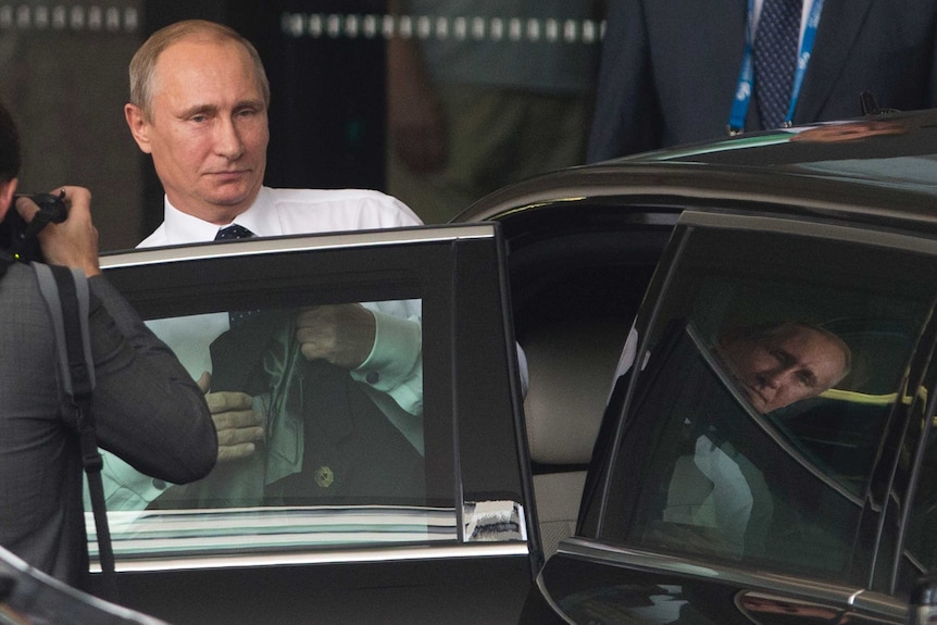 Vladimir Putin leaves his Brisbane hotel