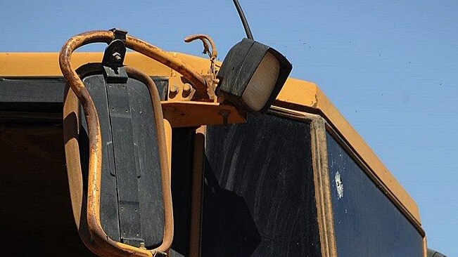 Bullet hole in the windscreen of one a front-end loader