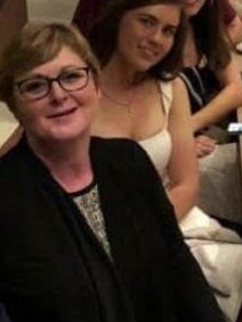 Brittany Higgins sitting behind Linda Reynolds at a dinner.