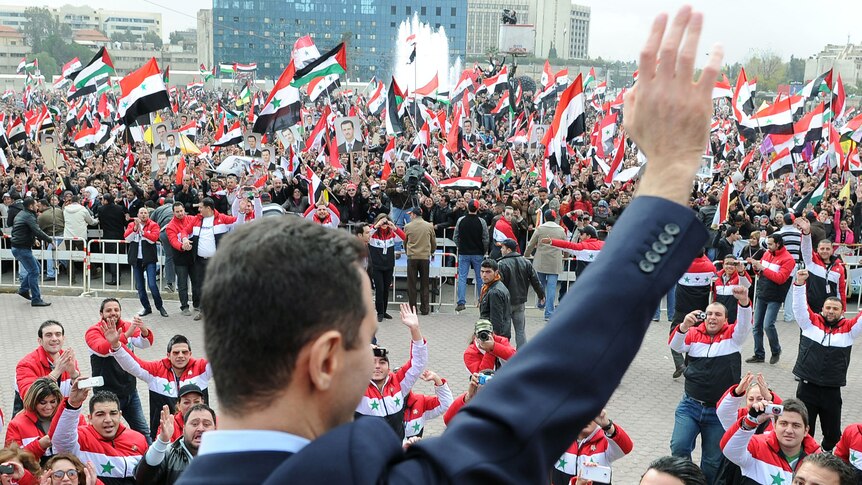 Syrian president Bashar al-Assad waves at supporters. (AFP: Wael Hamedan)