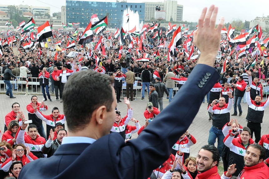 Syrian president Bashar al-Assad waves at supporters. (AFP: Wael Hamedan)