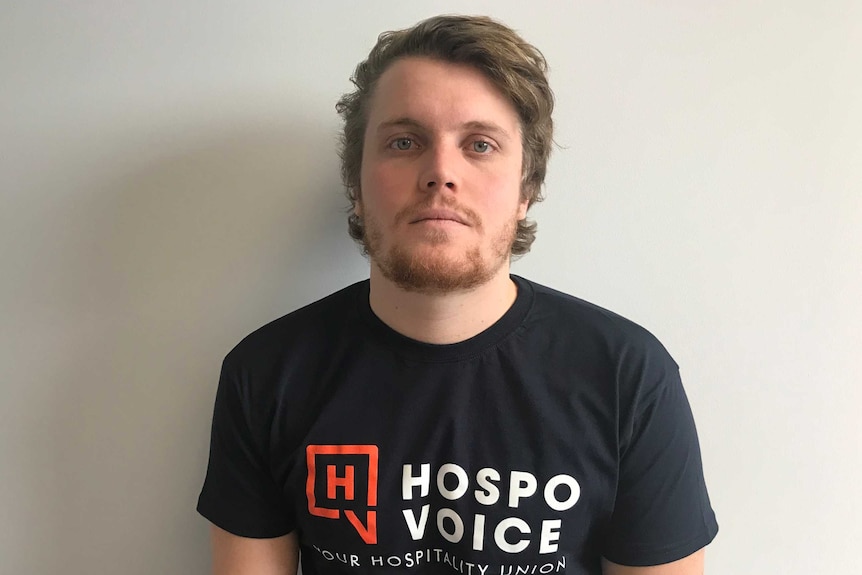Hospitality worker Oscar Shaw wears a 'Hospo Voice' t-shirt.