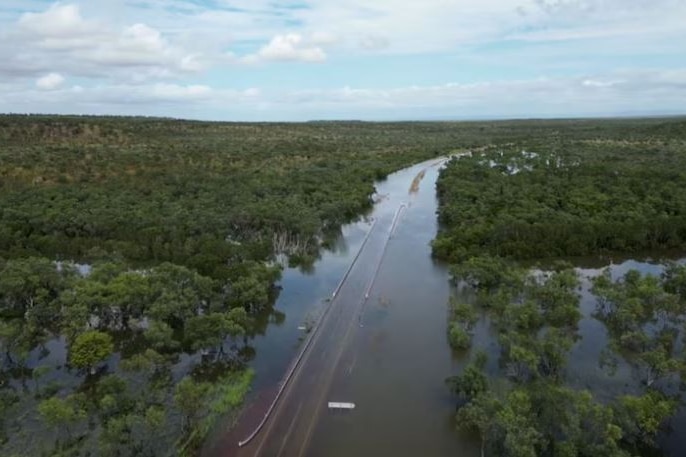 An aerial shot of a highway completely covered in floodwater.