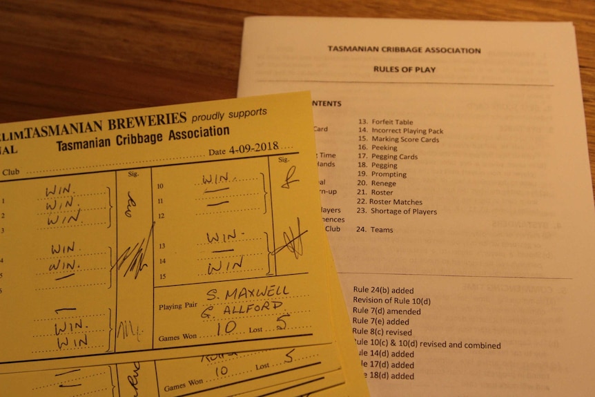 A cribbage score sheet and rules of play.