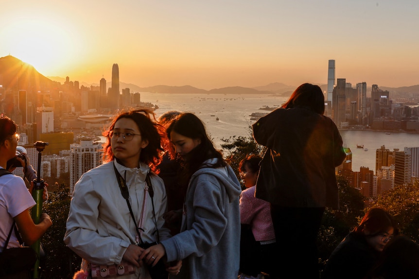 People taking photos of Hong Kong at sunset