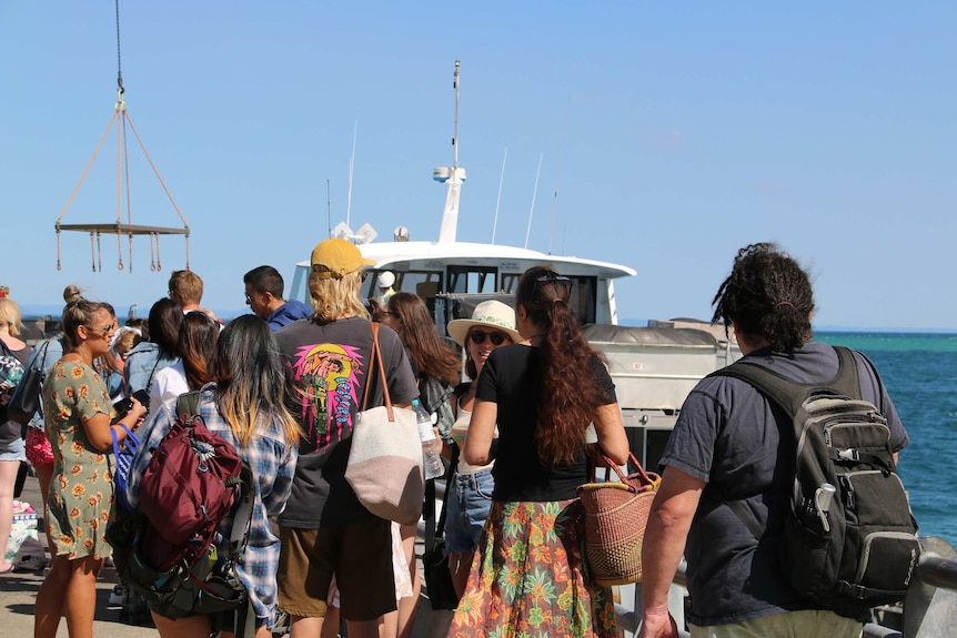 A group of yourists at Tangalooma Island Resort where a bacterial contamination has affected drinking water.