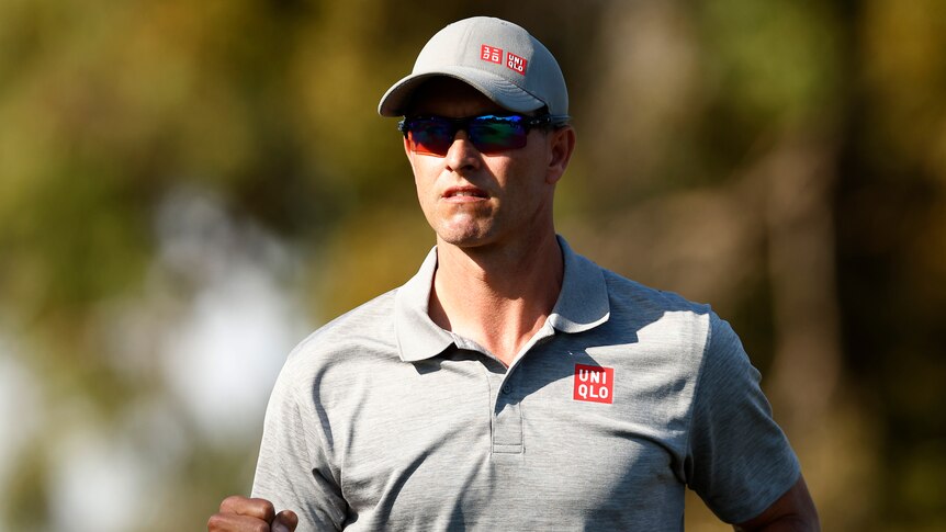 An Australian male golfer pumps his right fist at the Australian Open.