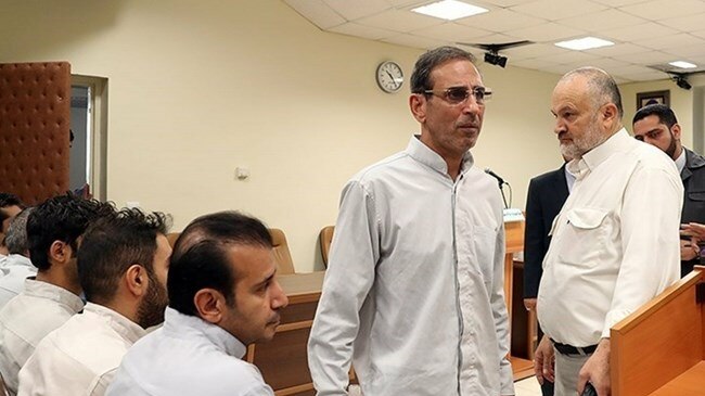 Vahid Mazloumin is seen appearing in court for the first time on charges of manipulating the currency market.