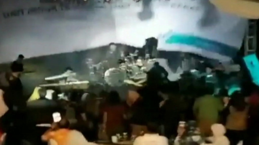 A tsunami wave crashed into a band as they were performing on a beach stage.