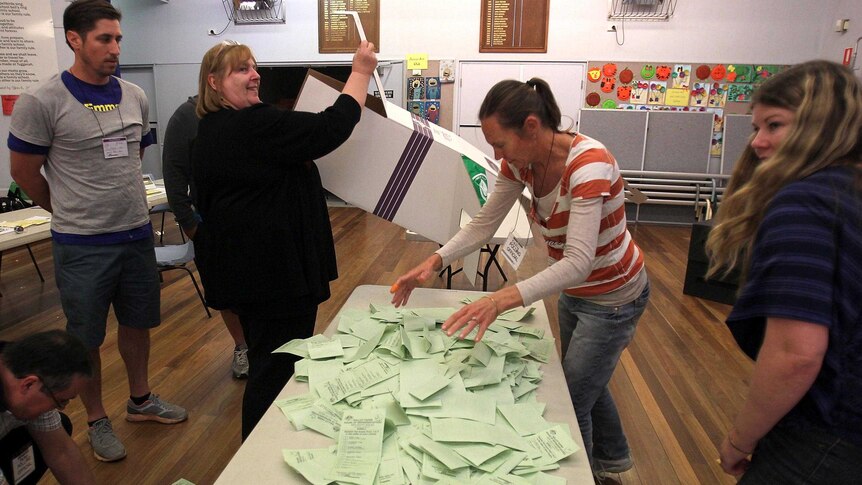 AEC staff tally ballot papers on federal election day.