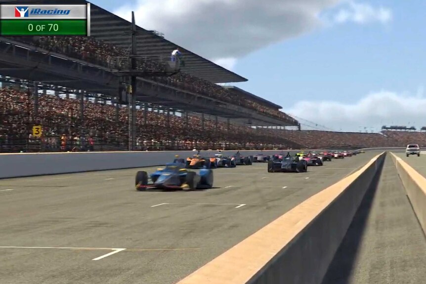 A blue car leads the field out starting a virtual IndyCar race, with the virtual stands packed.