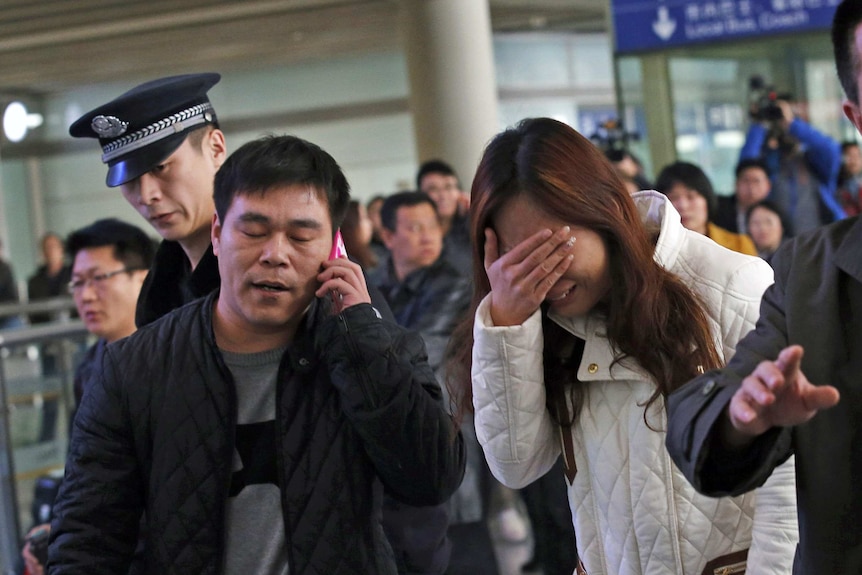 A relative of a MH370 passenger cries at Beijing International Airport in March 2014.