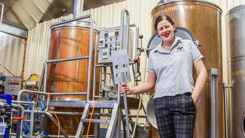 Mount Tamborine beer brewer Tanya Harlow standing in front of vats in a shed.