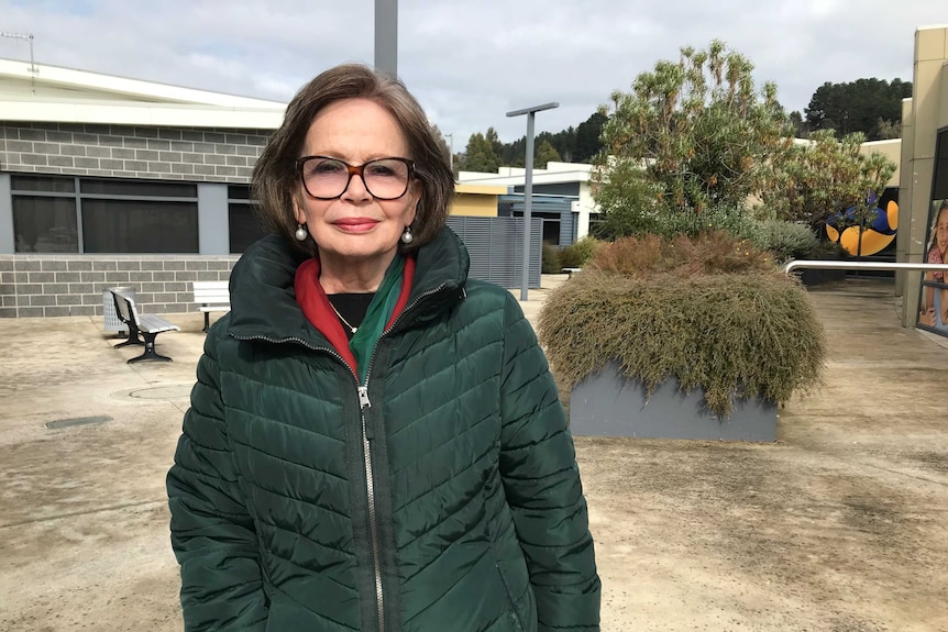 Christina Holmdahl, standing outside, smiles at the camera.