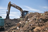 a bulldozer at a waste facility