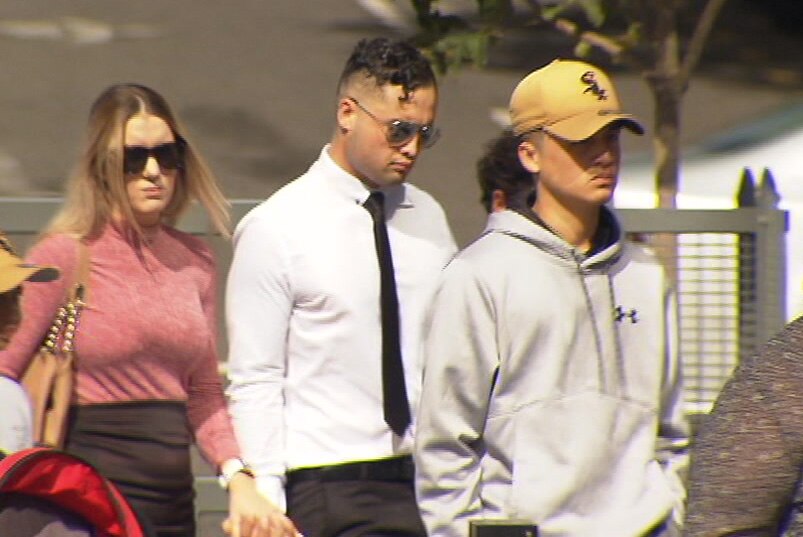 Tristan Heather (centre) walks to court in Brisbane on March 8, 2018.