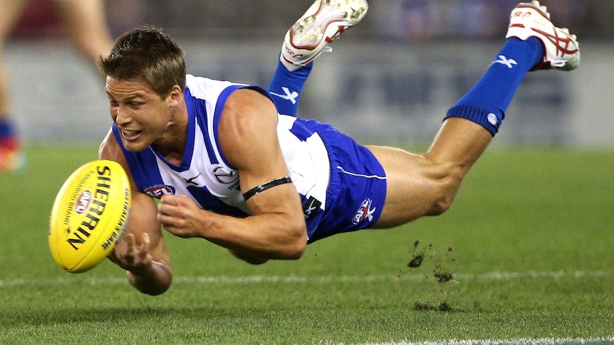 Andrew Swallow fires out a handpass for North Melbourne