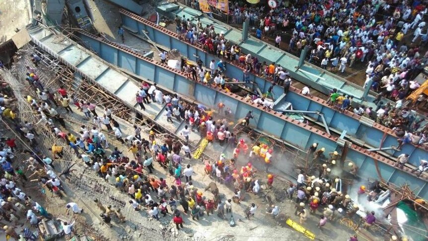 Aerial view of flyover collapse showing people attempting to free those trapped