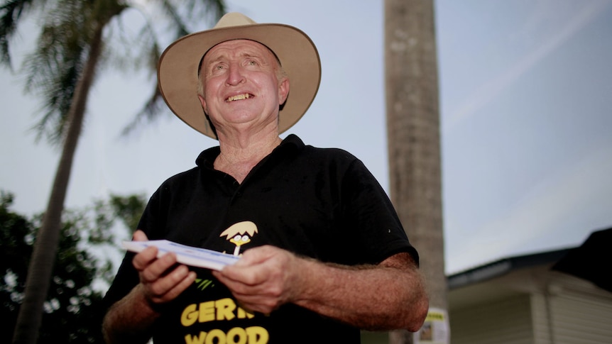 Independent MP Gerry Wood hands out pamphlets on election day at the Howard Reserve in Howard Springs in Darwin.