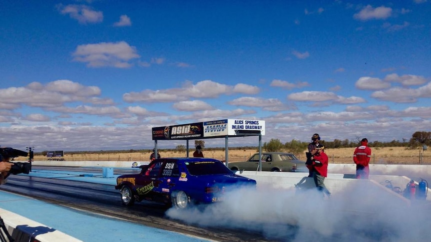 A driver takes off in heats at the Central Australian drag races.