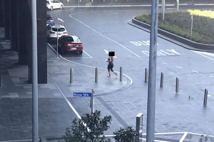 Screenshot of a footage showing someone walking towards a convenience store.