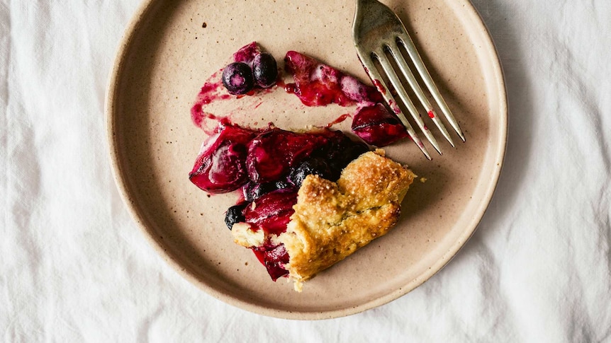 A slice of summer galette with stone fruit and blueberries on a plate, an easy dessert recipe.