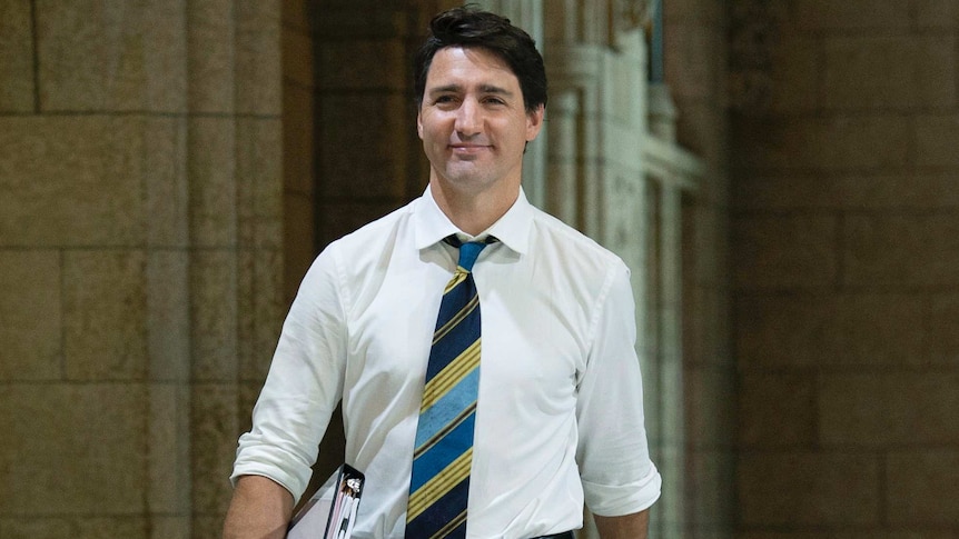 Canadian Prime Minister Justin Trudeau struts through parliament house in Ottawa