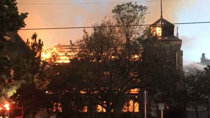 The heritage-listed St James Church, in Brighton, fully ablaze.