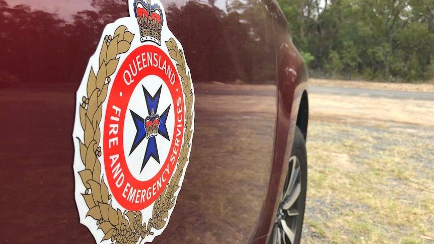 QFES logo on side of red fire vehicle parked at Deepwater fire station in central Queensland.