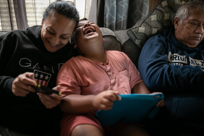 Jen and Marvin laughing over the iPad.