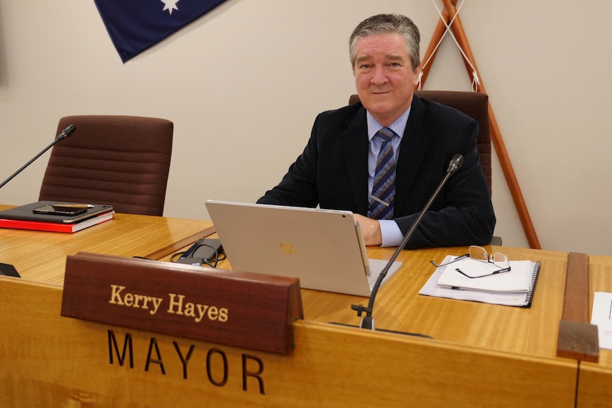 Kerry Hayes sits at his desk in the council chambers