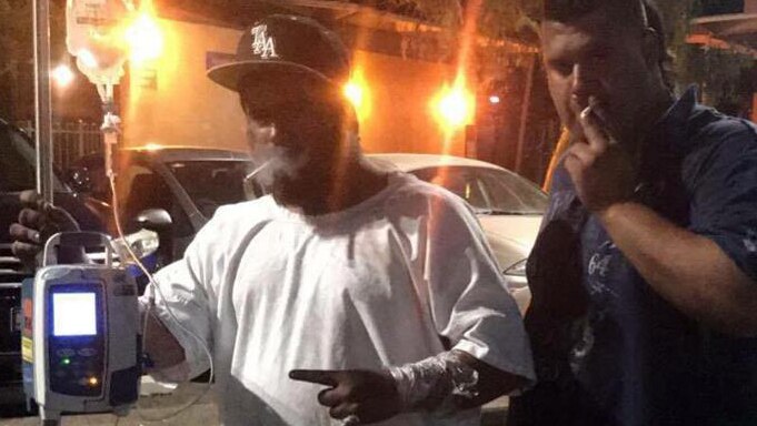 Jay Marafioti (left) has a cigarette outside the Alice Springs Hospital.