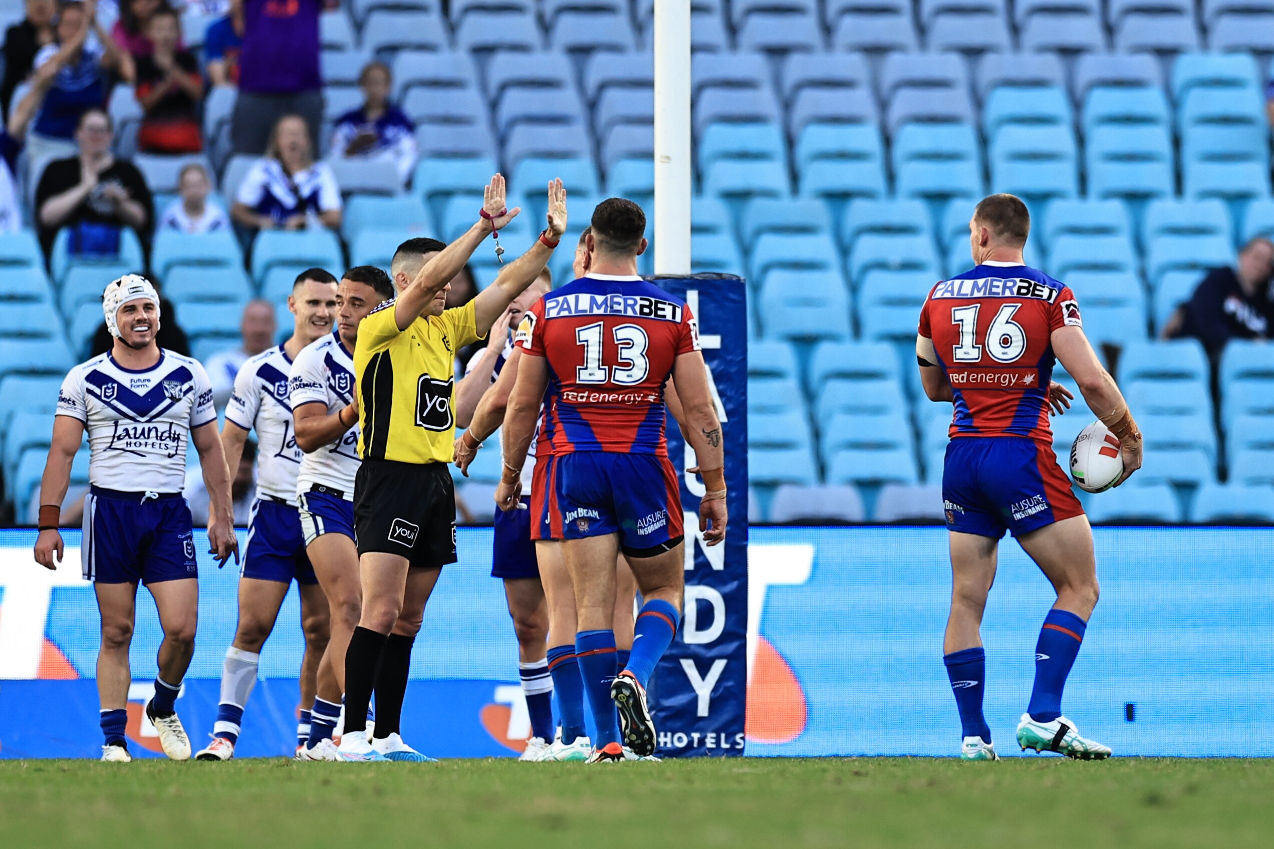 An NRL referee raises his hands in the air, sending a player to the sin-bin