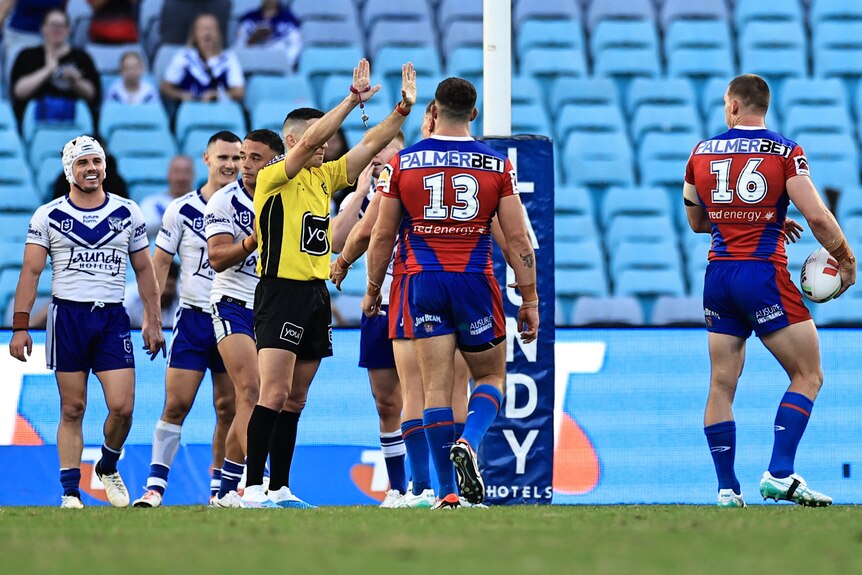 An NRL referee raises his hands in the air, sending a player to the sin-bin