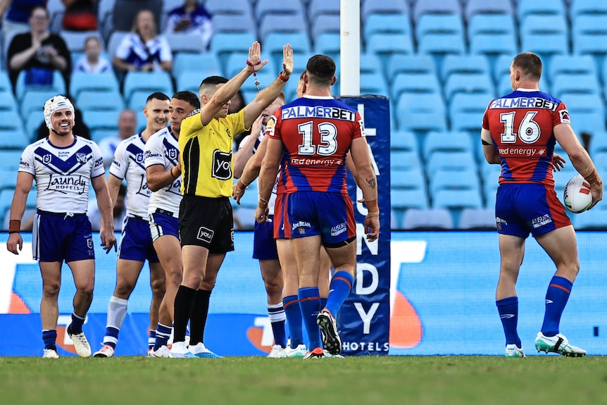 An NRL referee raises his hands in the air, sending a player to the sin-bin