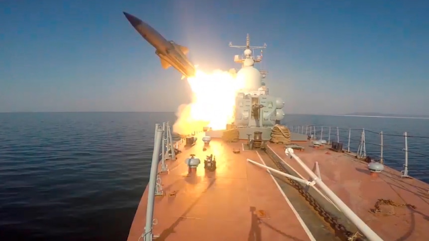 An anti-ship missile is fired from a ship at sea