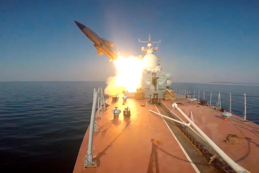 An anti-ship missile is fired from a ship at sea